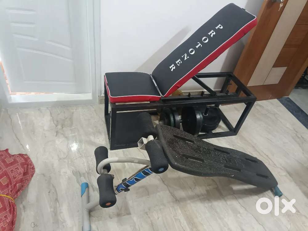 Exercise bench with storage and dumbbells