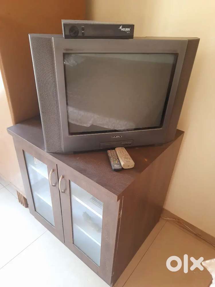 Sony desk TV with melbon free dish  and a table with cupboard
