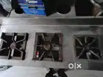 made of stainless steel and has three burners with individual knobs