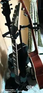 One Acoustic Guitar with  3  guitar Stand