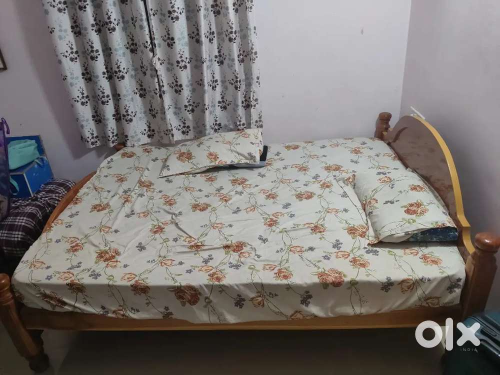 Wooden cot with mattress