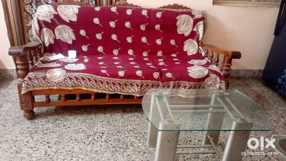 Wooden sofa and small glass teapoy
