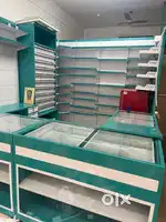 “Pharmacy display rack, stainless steel, height 8ft, used”