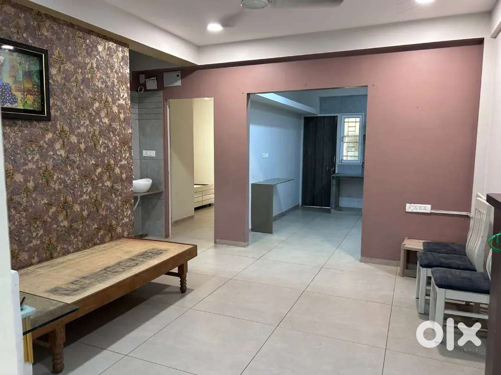 Bed cupboard dining table and light fans behind kanha city