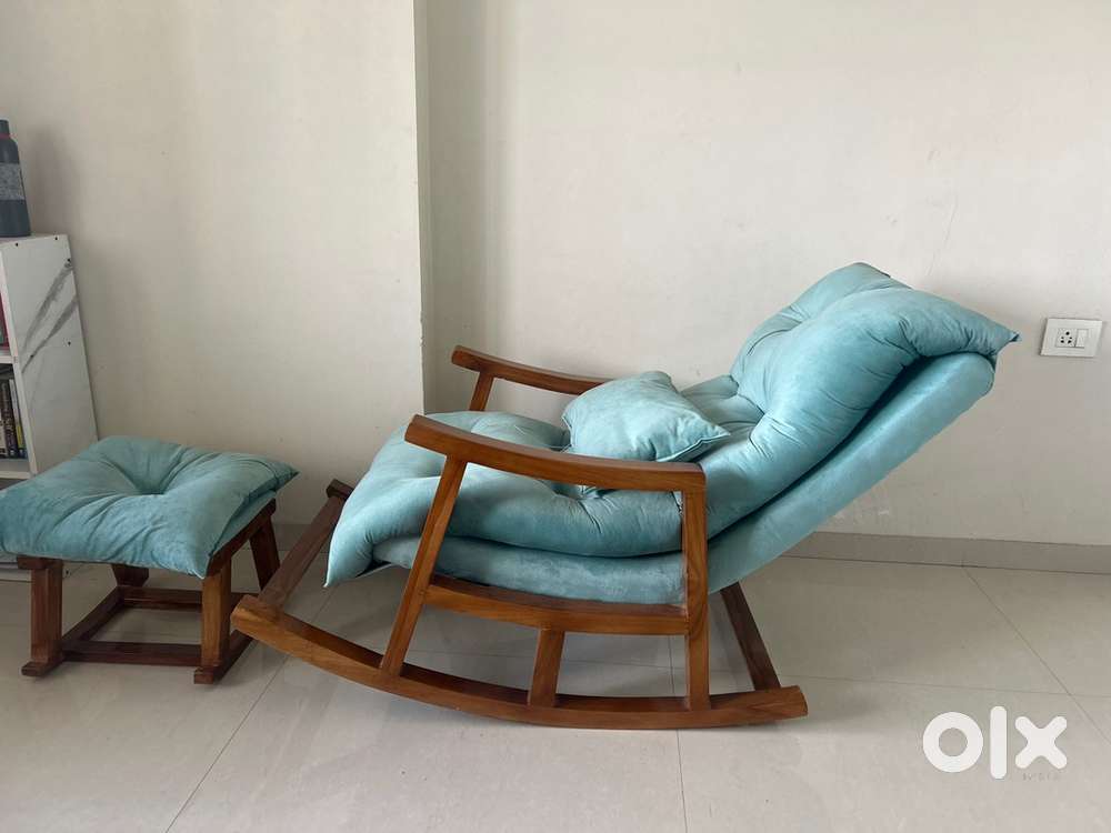A wooden good quality resting chair with stool with cushions