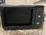 Black coloured microwave in working condition