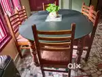 Teakwood 6 seater dining table with glass top.