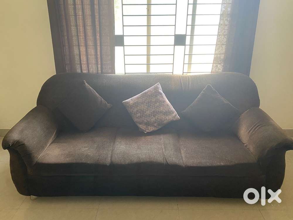 Brown sofa and TV stand