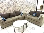 Sofa with few pillows along with a  table set of 2