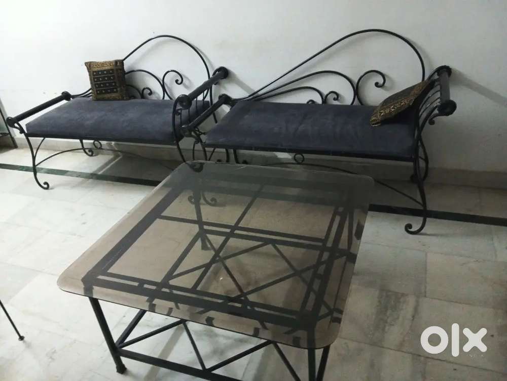 Two wrought iron couches, one glass center table & two side stools.