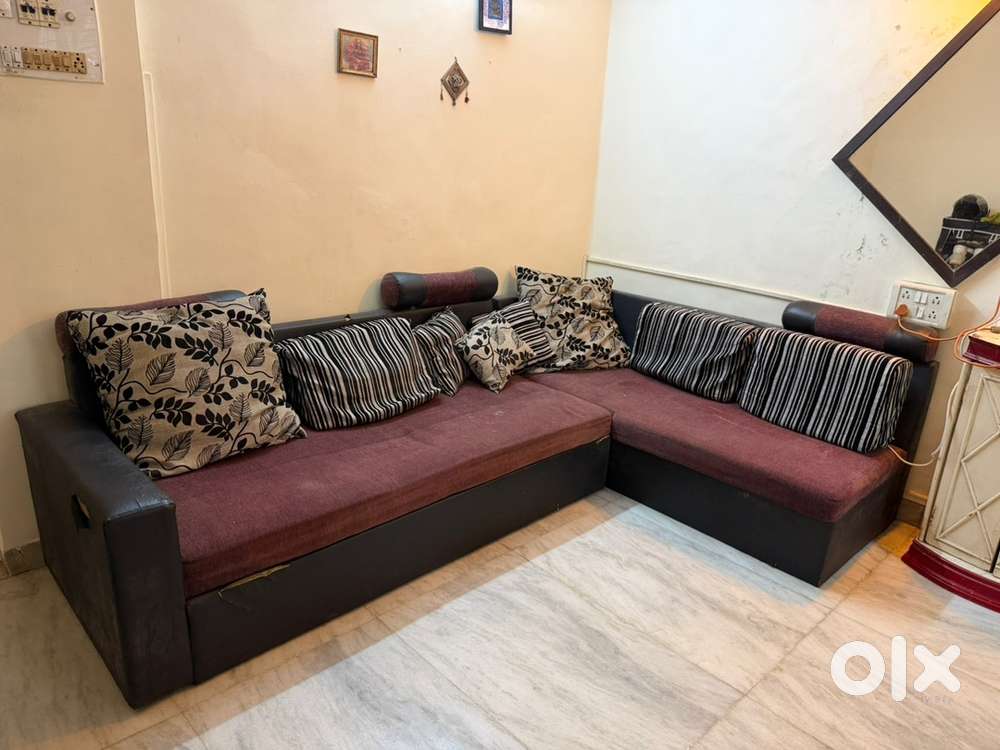 L shape sofa cum bed with pillows