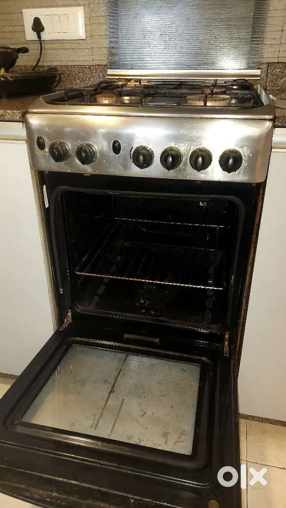 Gas operated cooking range with oven, grill and four burner.