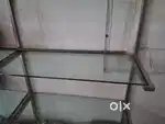 Glass shelf rack with steel pipe