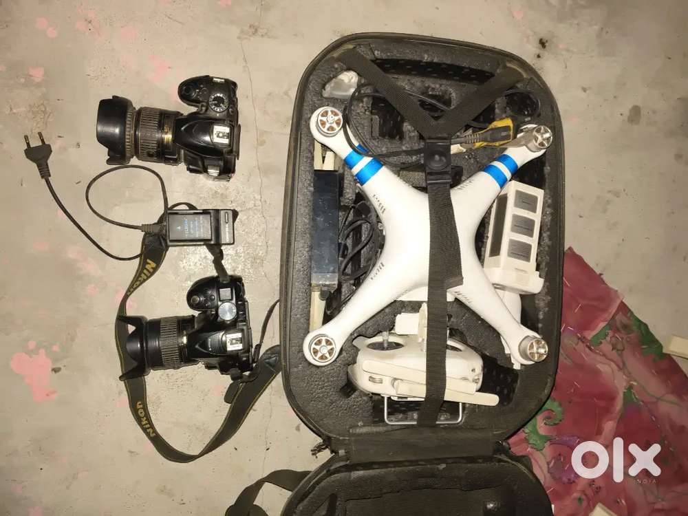 Two Nikon camera  and one panthon dron with battery and charger