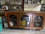 This is a wooden storage cabinet / sideboard with glass doors.