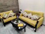 A three seater couch, two seater couch and a coffee table(godreg)