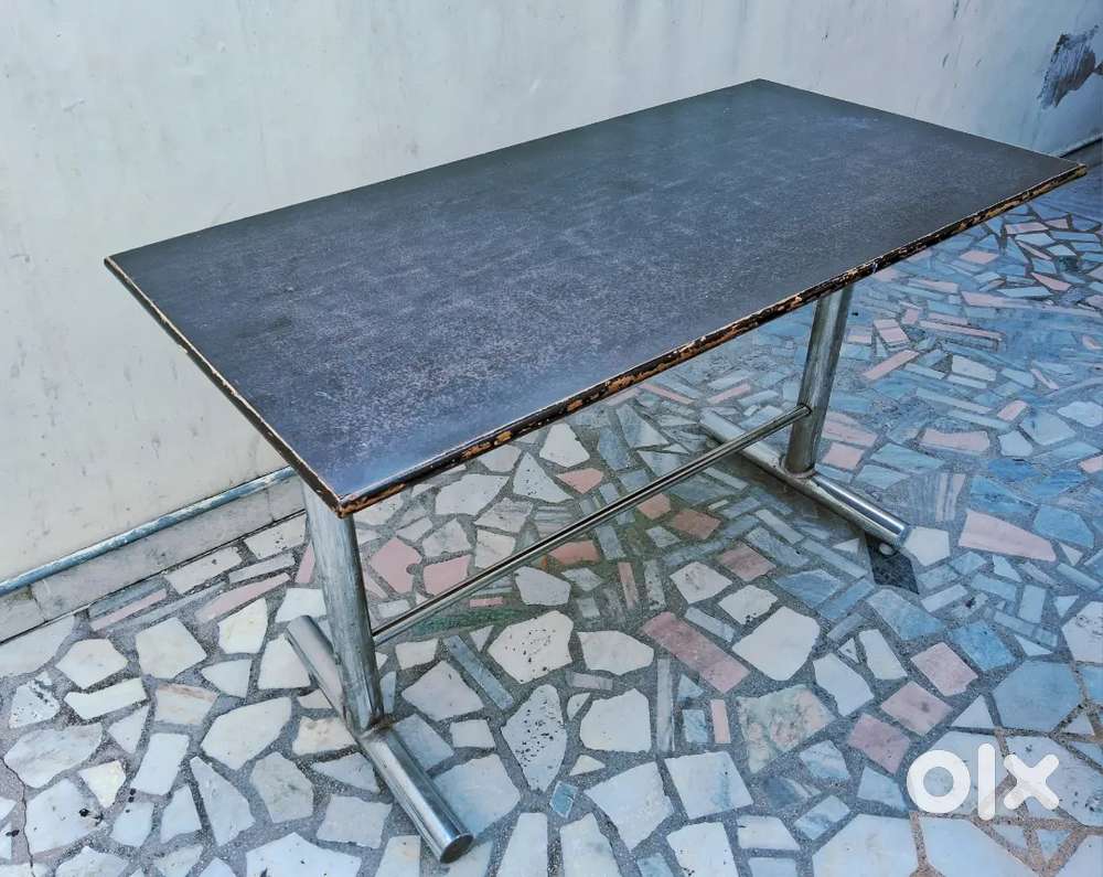Used table metal frame with laminated wooden top