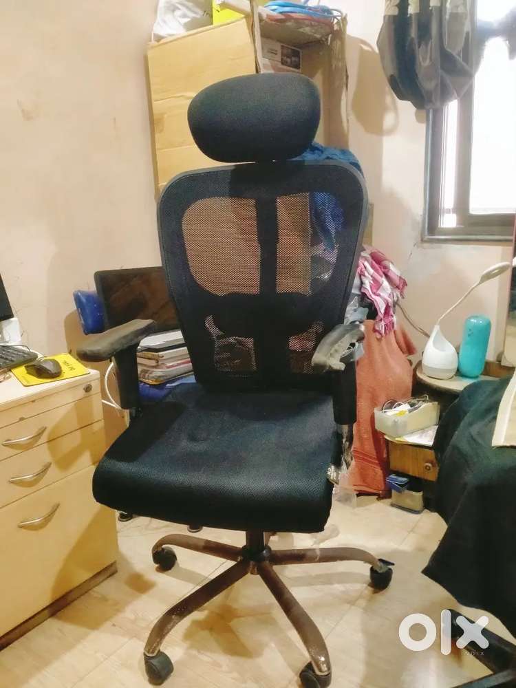 Revolving chair with headrest and lumbar support.