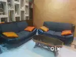 3 black sofa with a wooden glass top table and 6 cushions