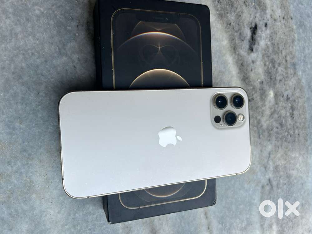 iPhone 12 pro, gold coloured with accessories near podar college