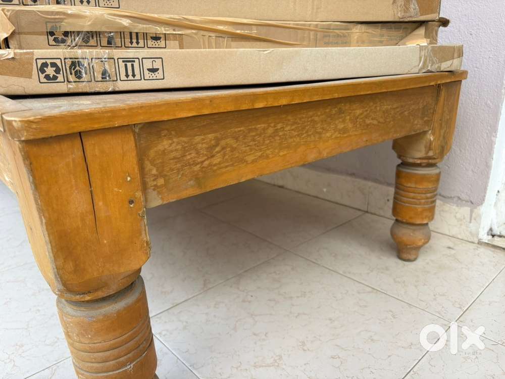 A wooden single cot