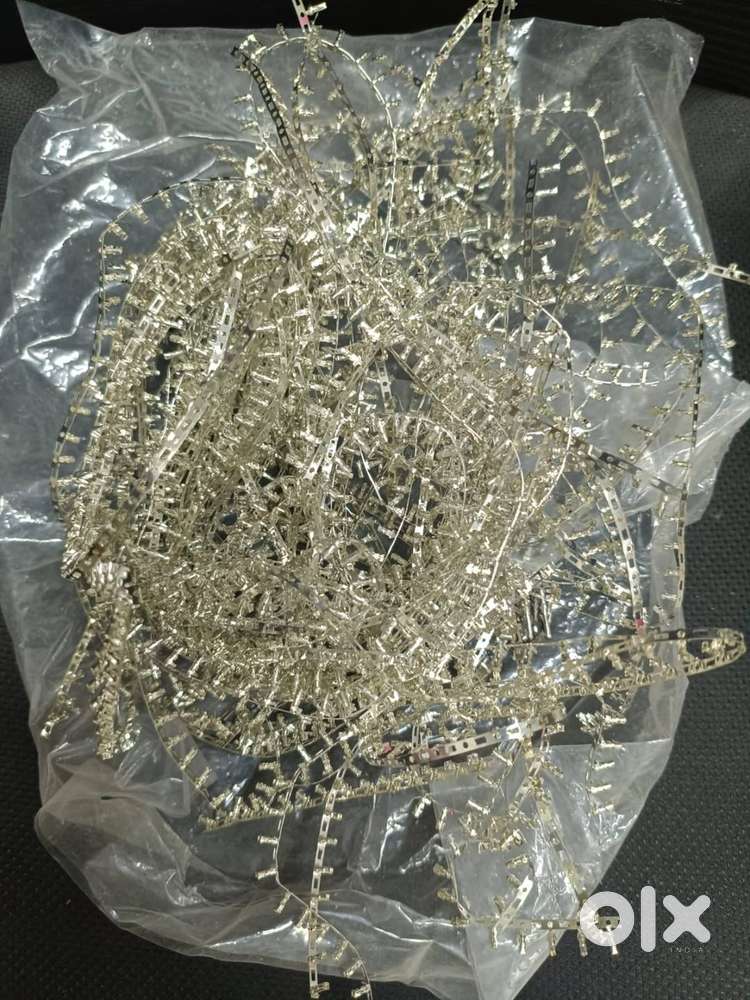tangled pile of metallic connector strips or terminal pins.
