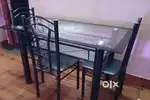 Glass top dining table with 4 chair