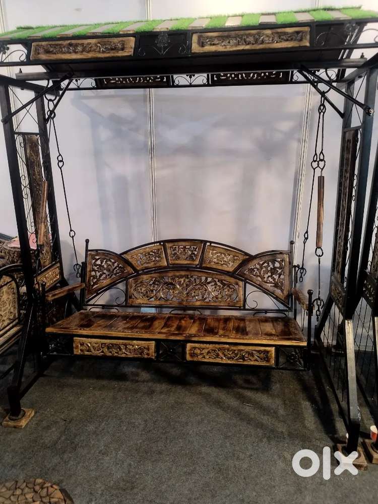 Wrought iron and wooden swing