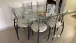 Glass top dining table with 6 steel chairs available for sale