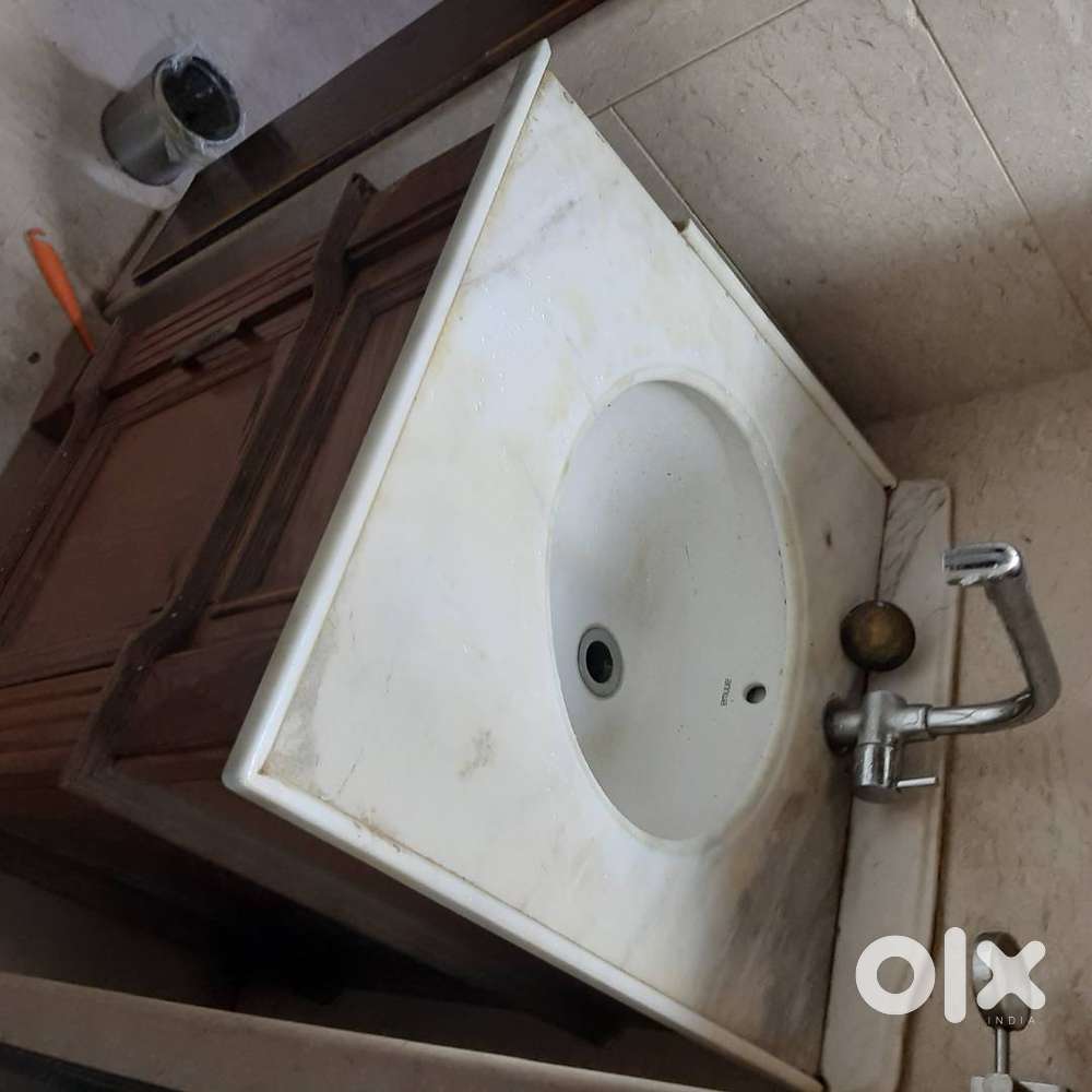 Wash basin with wooden cabinet and mirror