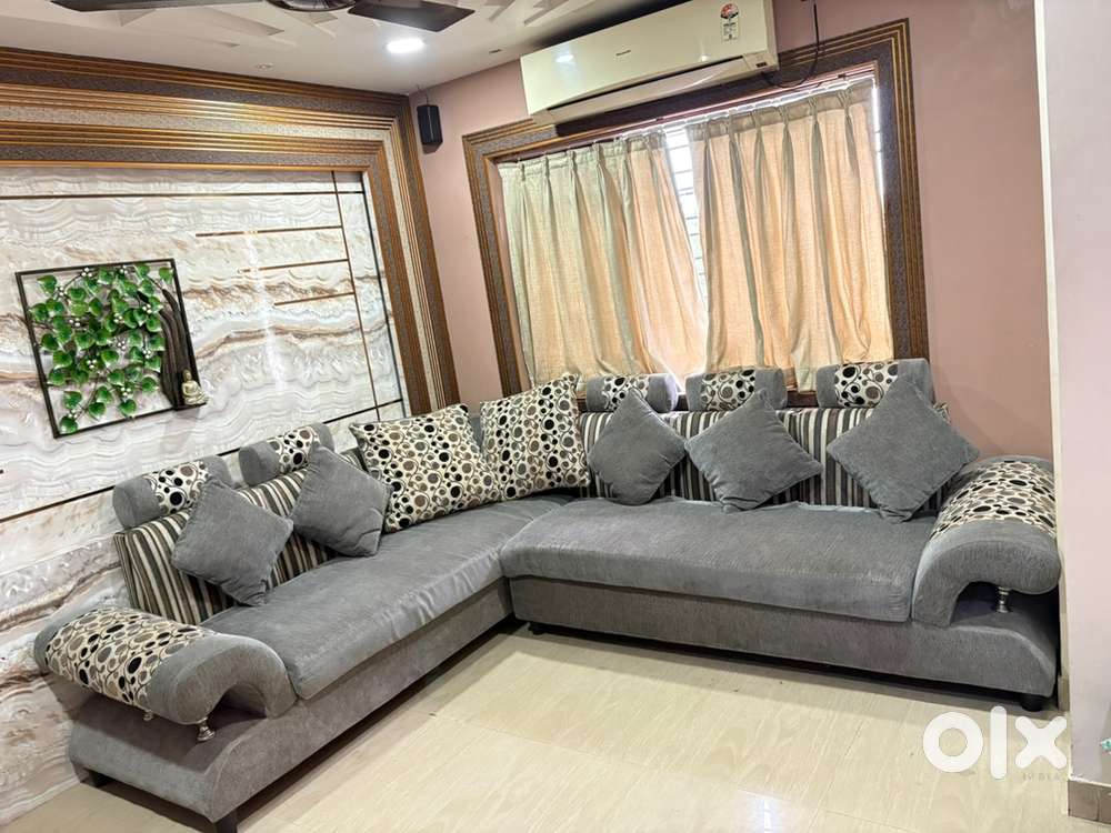 L-shaped 6-7 Seatet Sofa, with elegant grey colour.