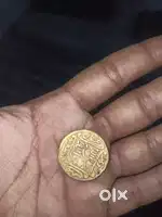 The image shows a gold Mohur coin from the Mughal Empire,