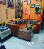 L-shaped sofa with matching centre table for sale.