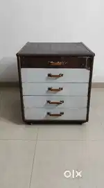 Chest of drawers along with attached wheels.
