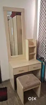 Dressing table with storage drawers and sitting cushioned ottoman