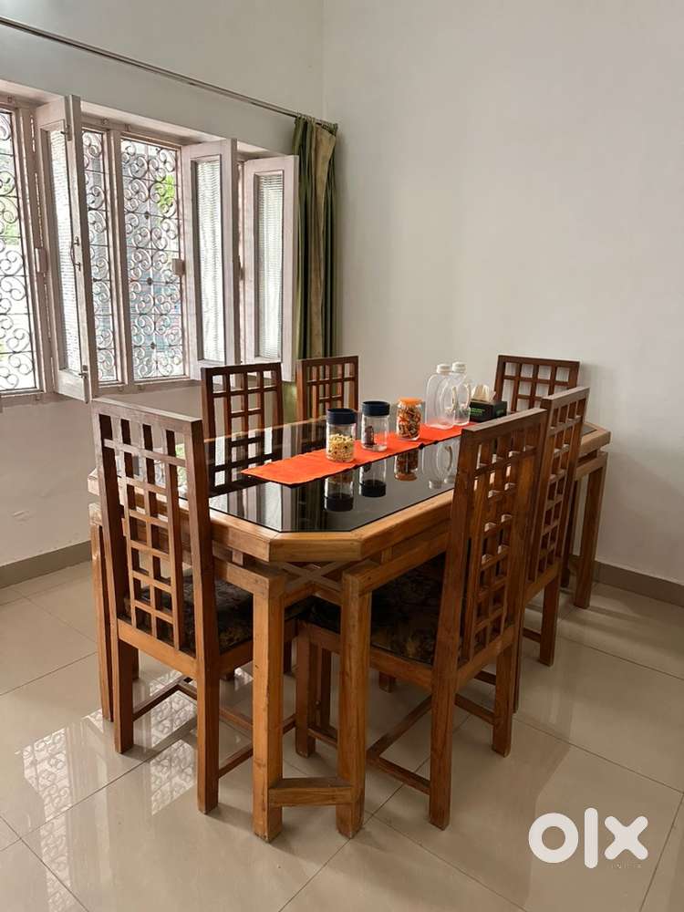 Teak wood dinning table with attached glass