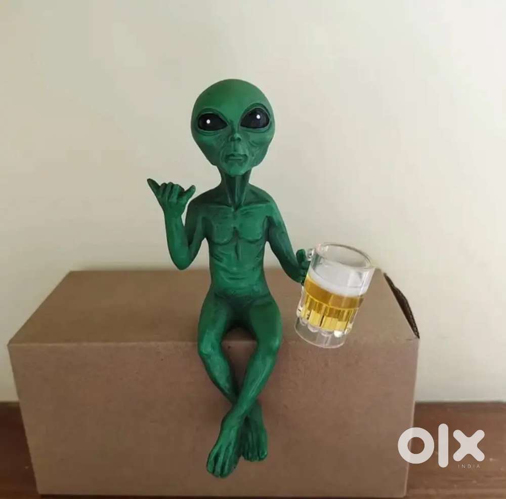Alien drinking beer statue