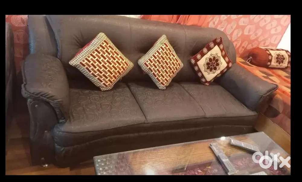 7 seater black leather sofa with  glass center table is for sale.