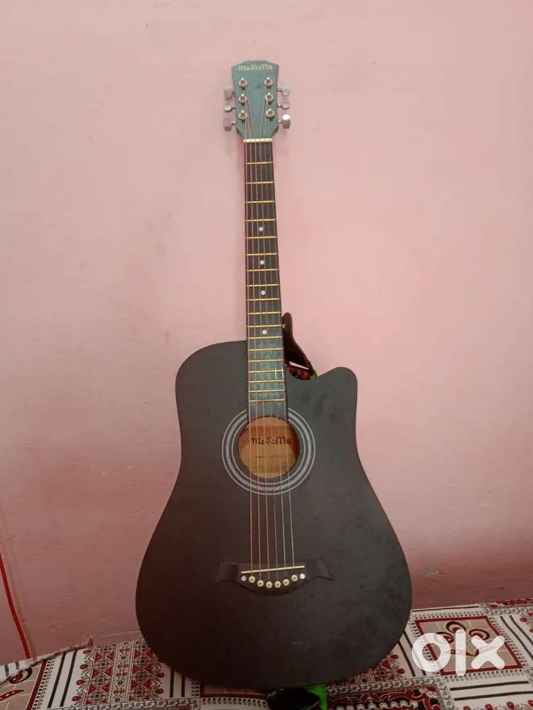 New guitar with belt and kapo and wire