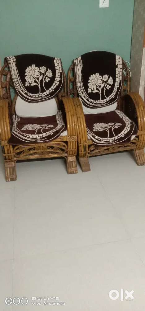 Cane nicely designed sofa with cushions.