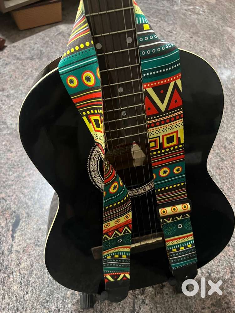 Guitar with strap, bag and stand.