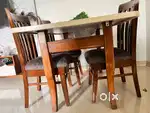 Wooden dining table with glass top