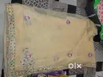 Elegant Beige Net Saree with Colorful Embroidery and Stone Work