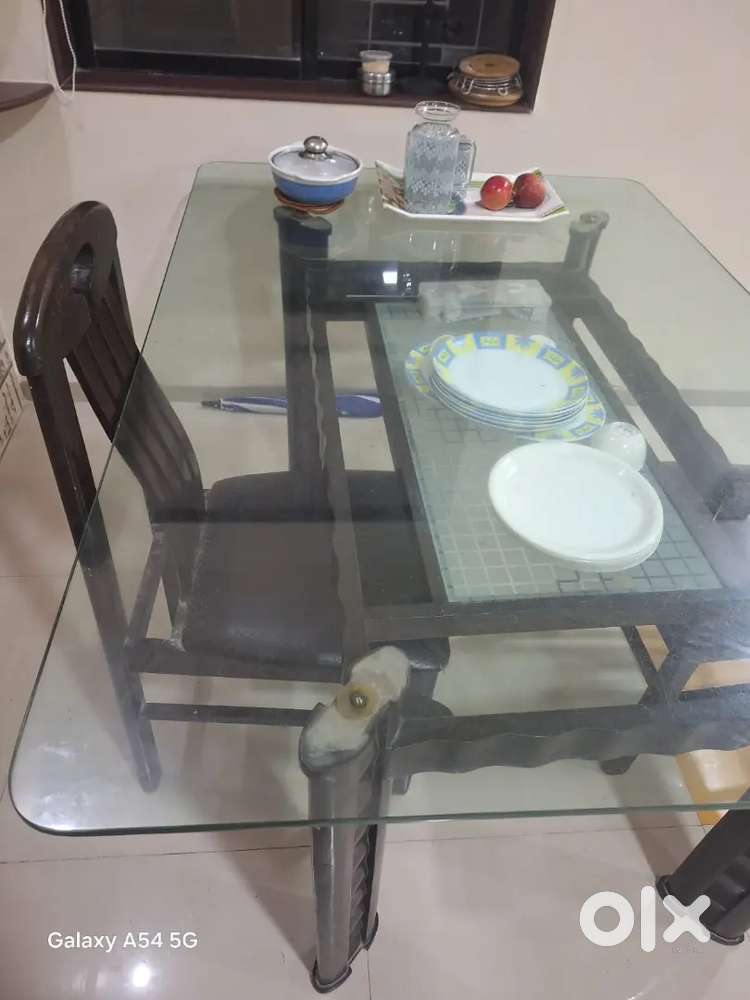 Dinning Table Glass is the top and Wooden base
