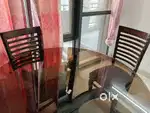4 Seater Sagwan wood dining table with glass on top