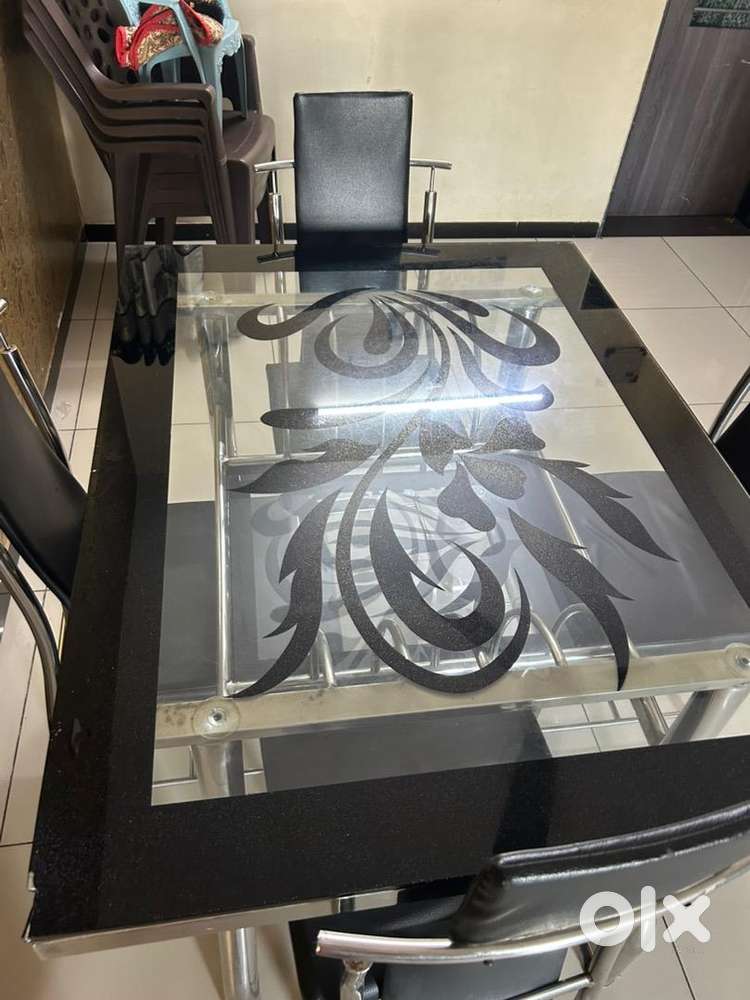 4 chair table, top table made up of glass.