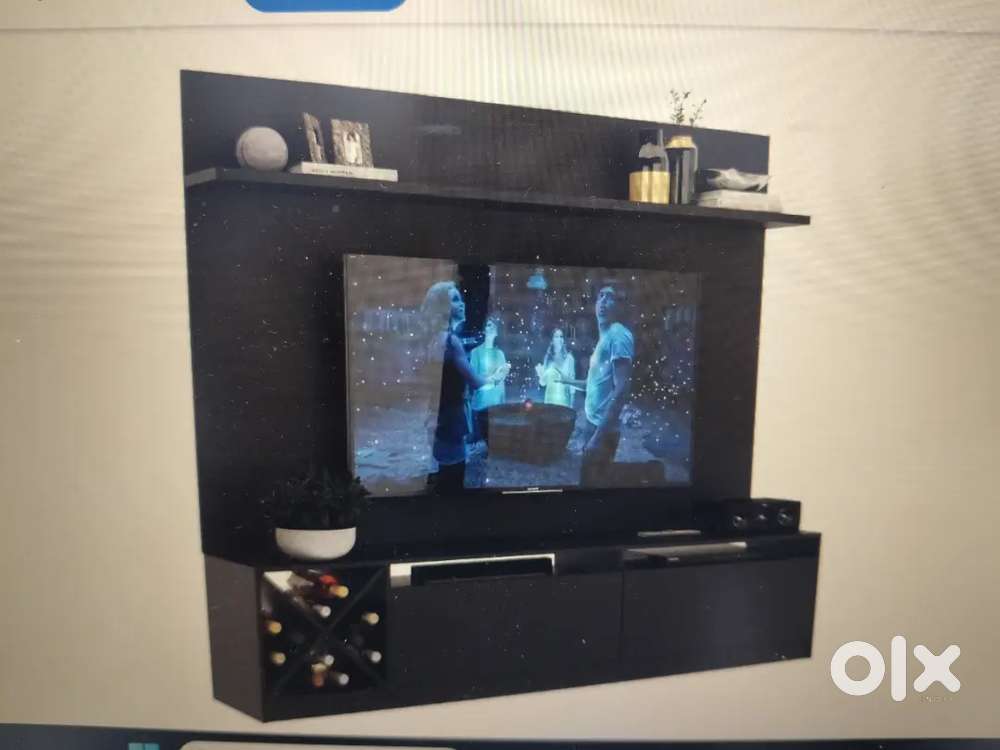 TV set dark brown in color with bottom shelves