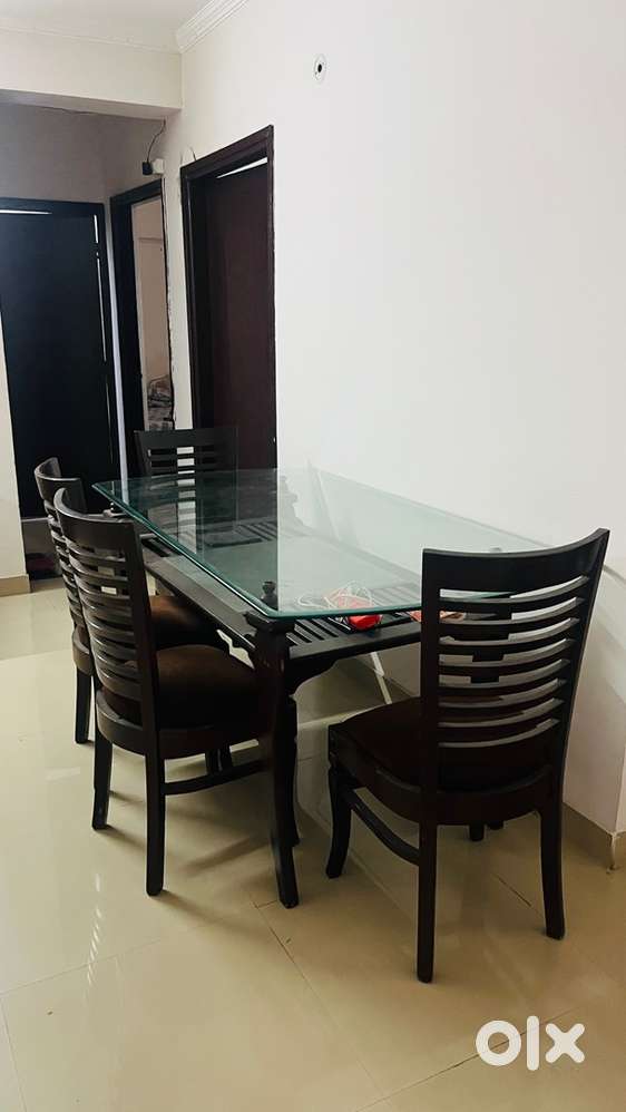 Wooden Dining table with glass top with 6 wooden Chairs