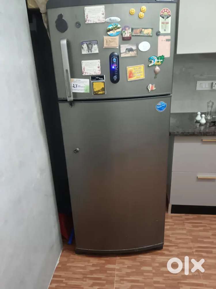 Double-door Whirlpool refrigerator in good working condition.