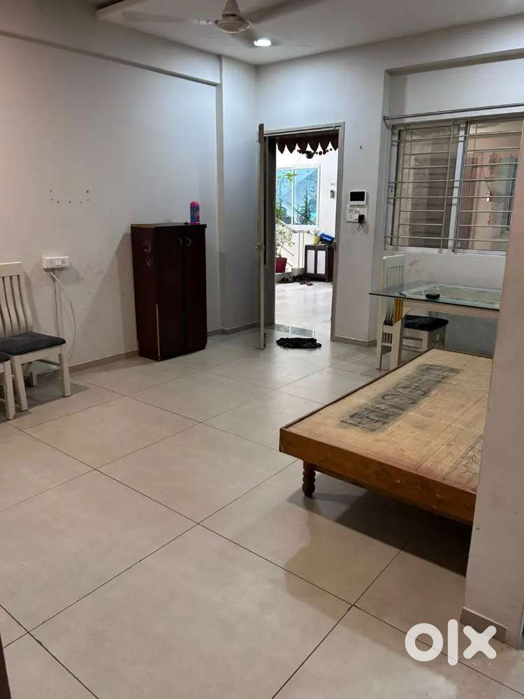 Bed cupboard dining table and light fans behind kanha city